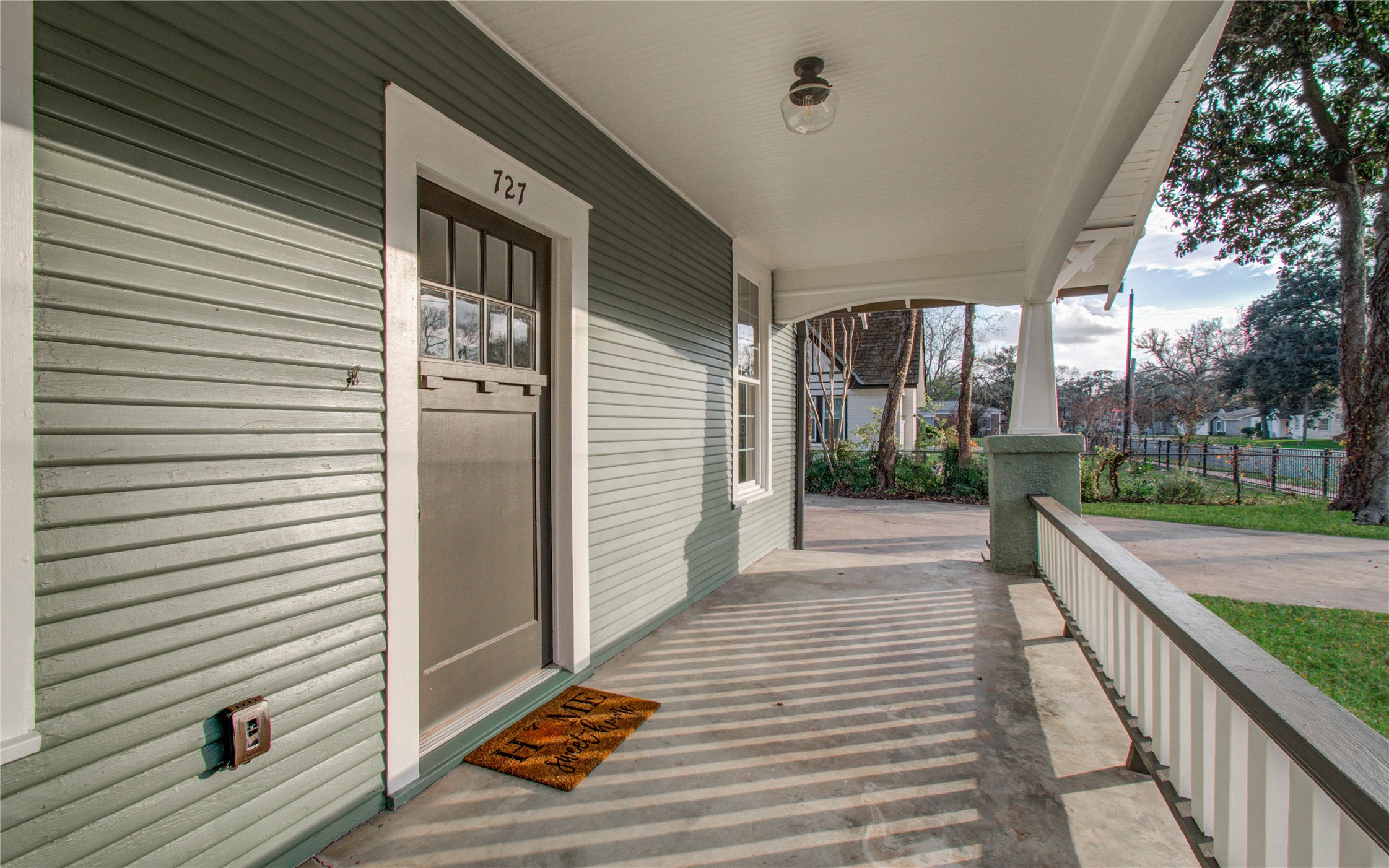 727 Travis Street Columbus, TX 78934 - Photo 7 of 36 a view of a balcony with floor to ceiling windows and wooden floor