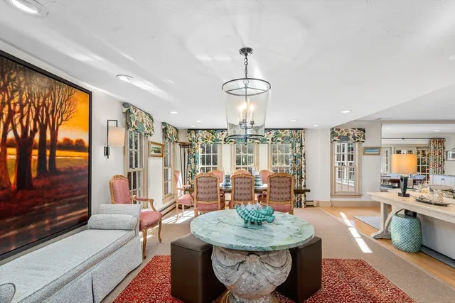 a living room with furniture a lamp and a potted plant