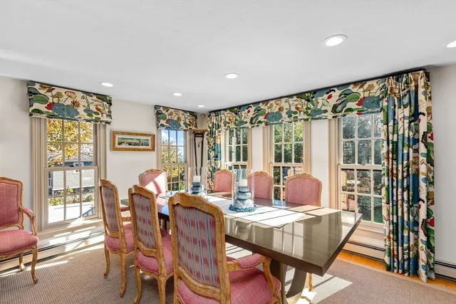 a living room with furniture a wooden floor and next to a window