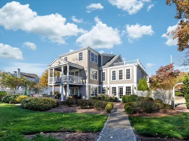 a front view of a house with a garden and plants