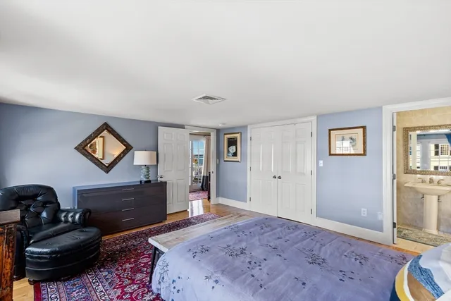 a bed room with a bed and a chair