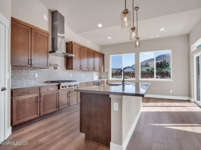 a large white kitchen with large windows and white cabinets