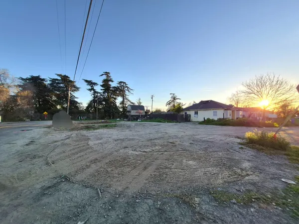 a view of a dry yard with sunset view