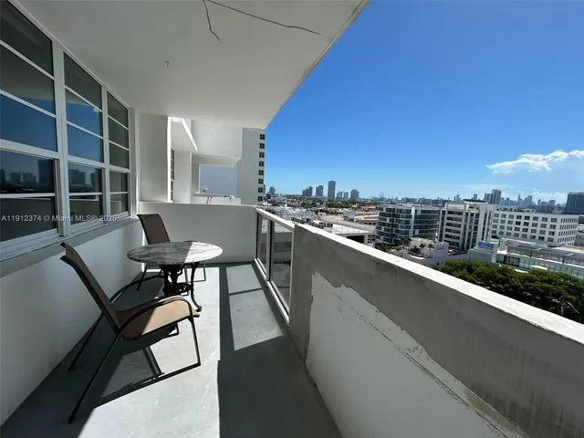 a roof deck with table and chairs