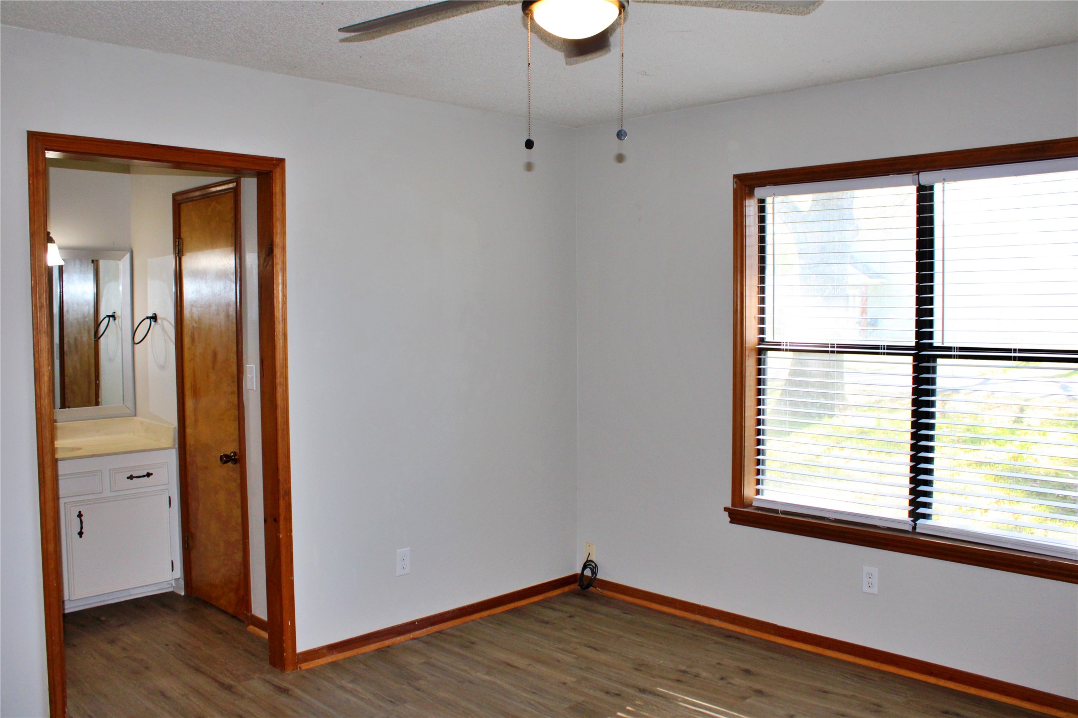 1126 Jackson Street Columbus, TX 78934 - Photo 20 of 40 a view of an empty room with wooden floor and a window