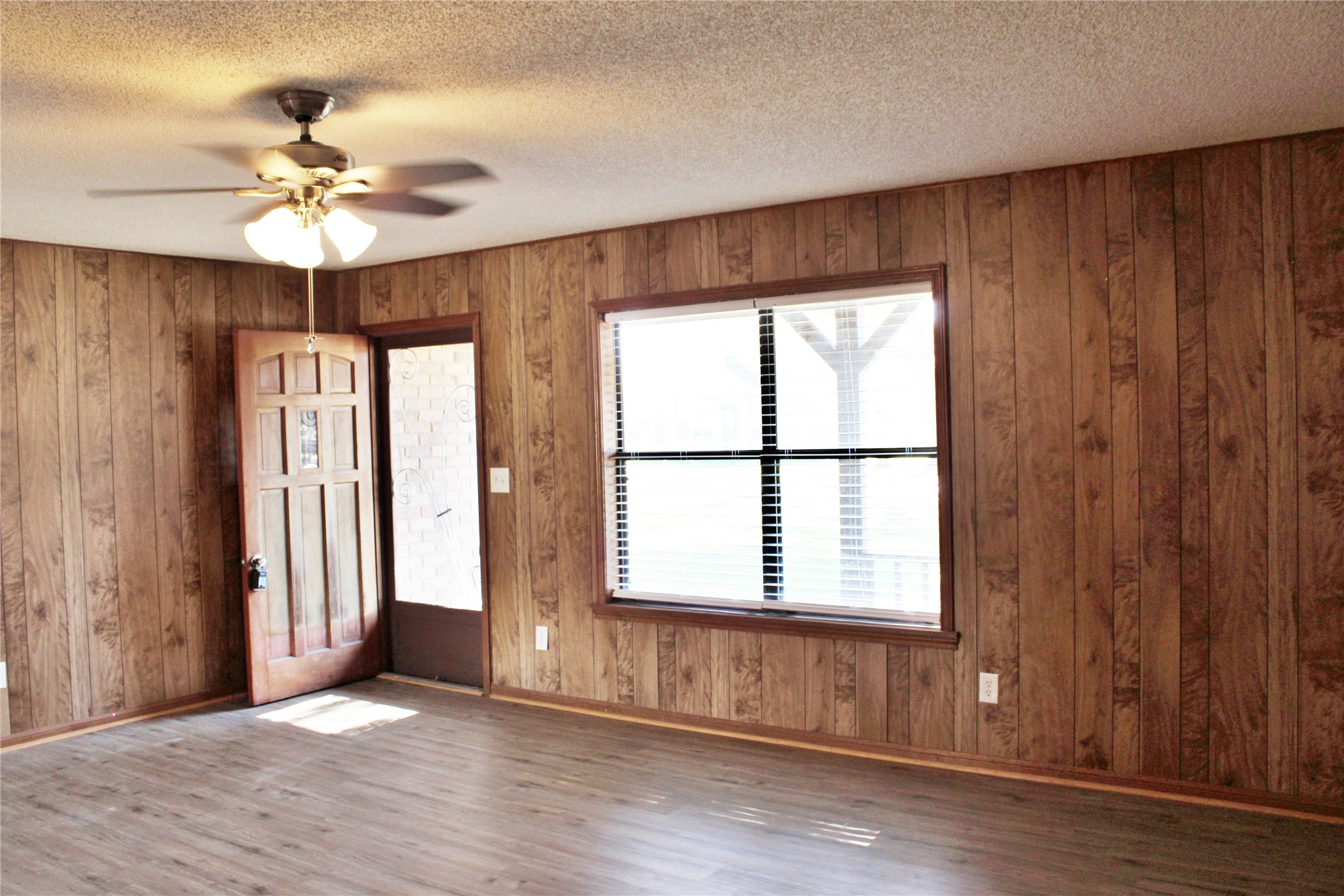 1126 Jackson Street Columbus, TX 78934 - Photo 2 of 40 an empty room with wooden floor fan and windows