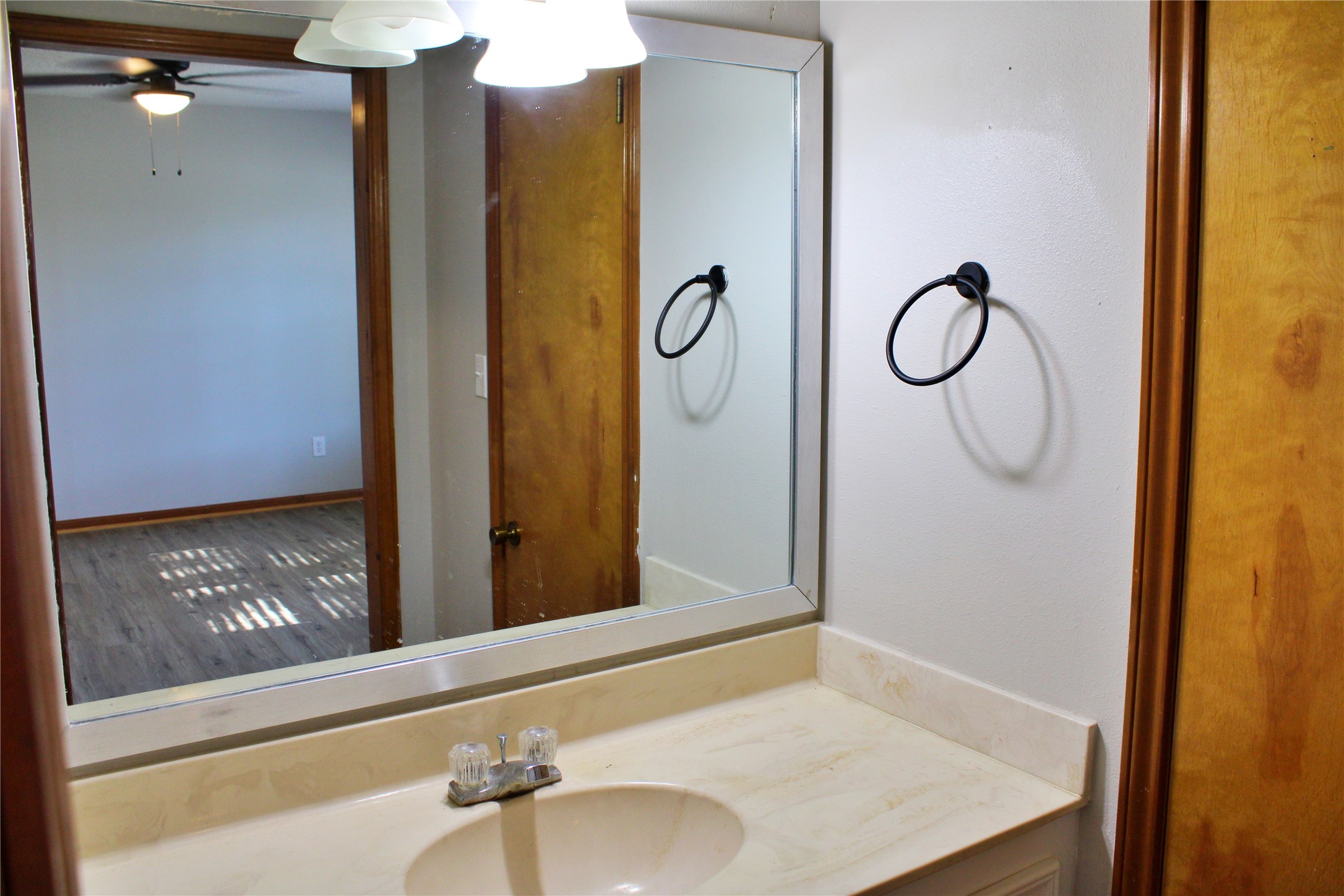 1126 Jackson Street Columbus, TX 78934 - Photo 24 of 40 a bathroom with a granite countertop sink and a mirror