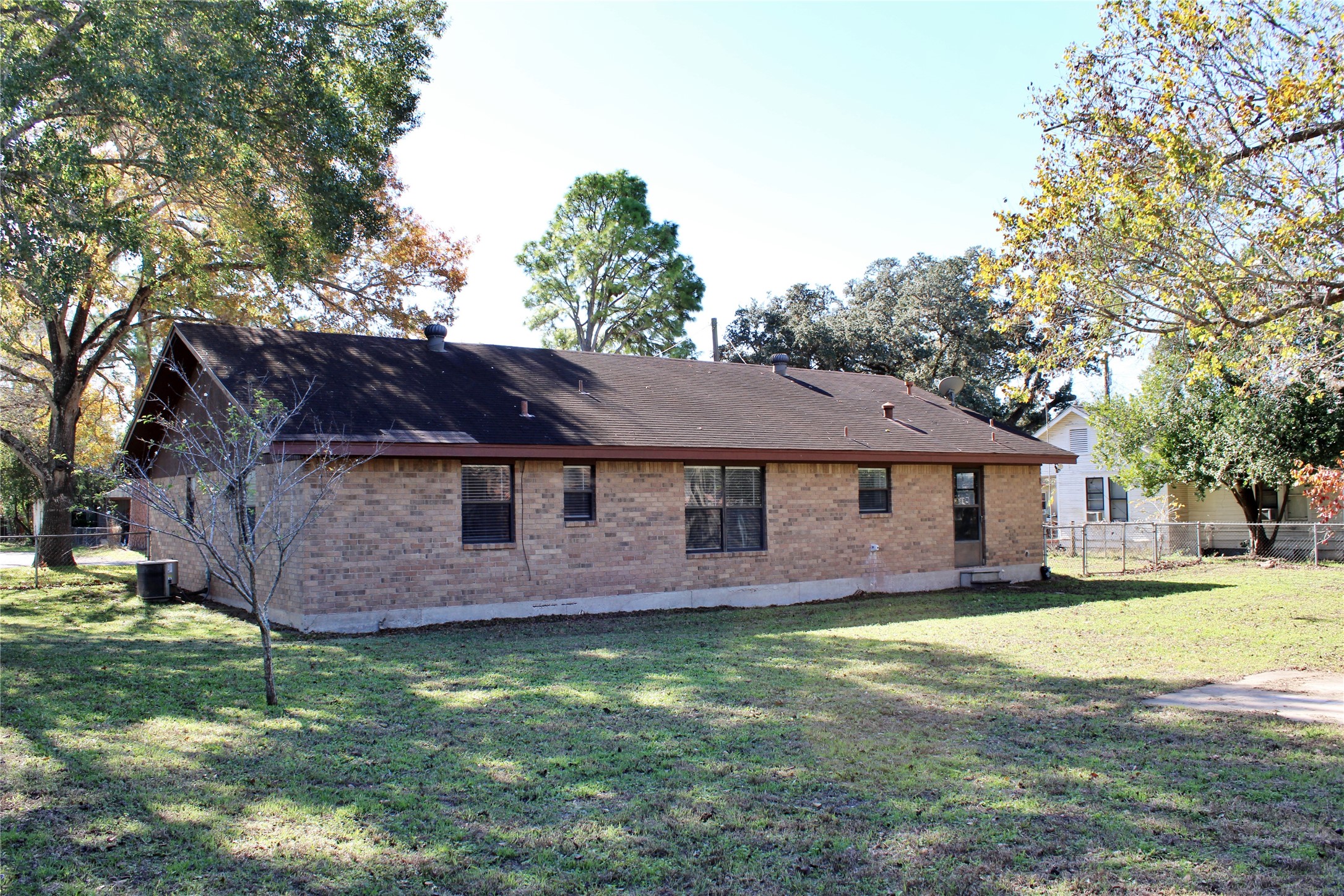 1126 Jackson Street Columbus, TX 78934 - Photo 37 of 40 a view of a house with a big yard and large tree