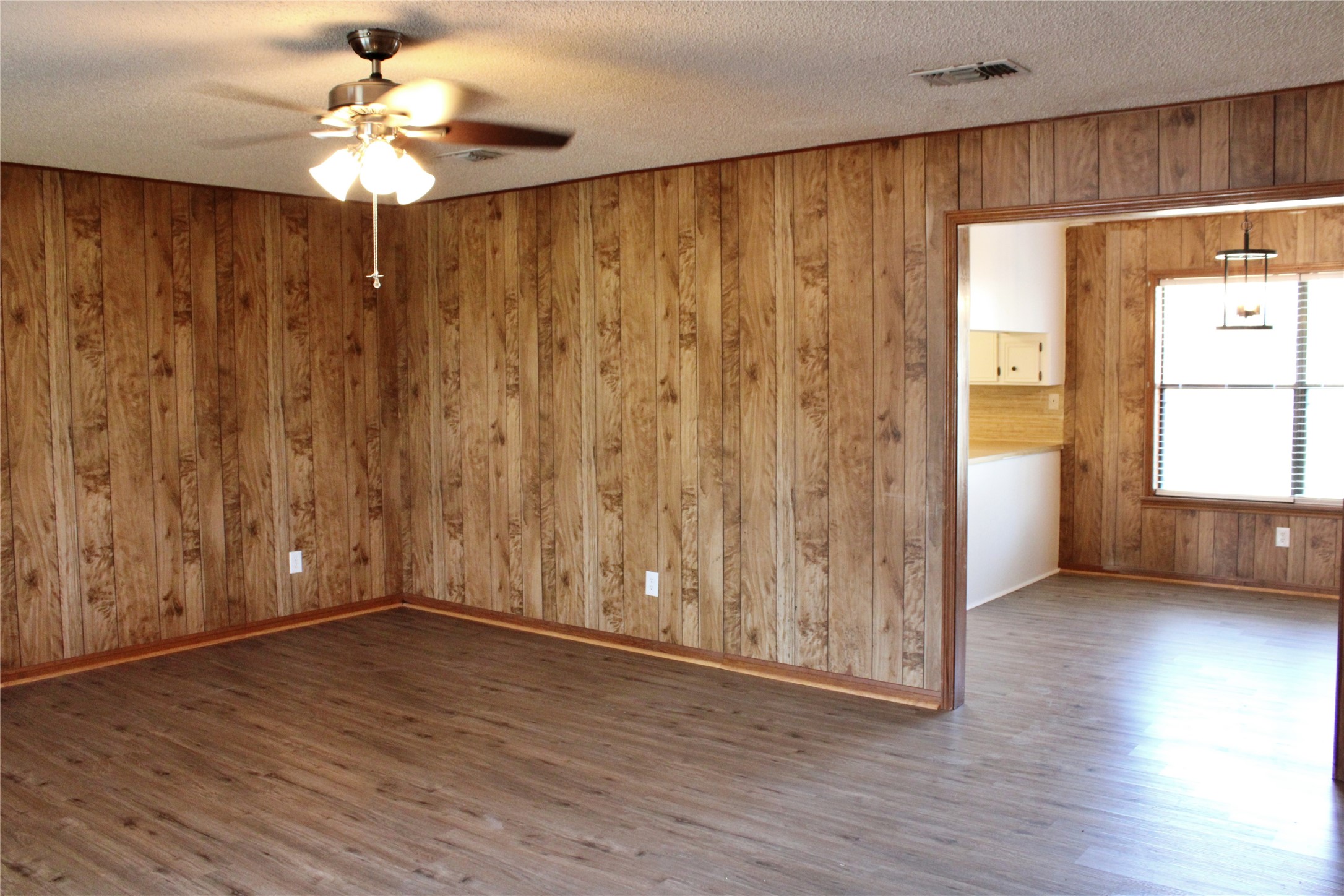 1126 Jackson Street Columbus, TX 78934 - Photo 5 of 40 a view of an empty room with a window and wooden floor