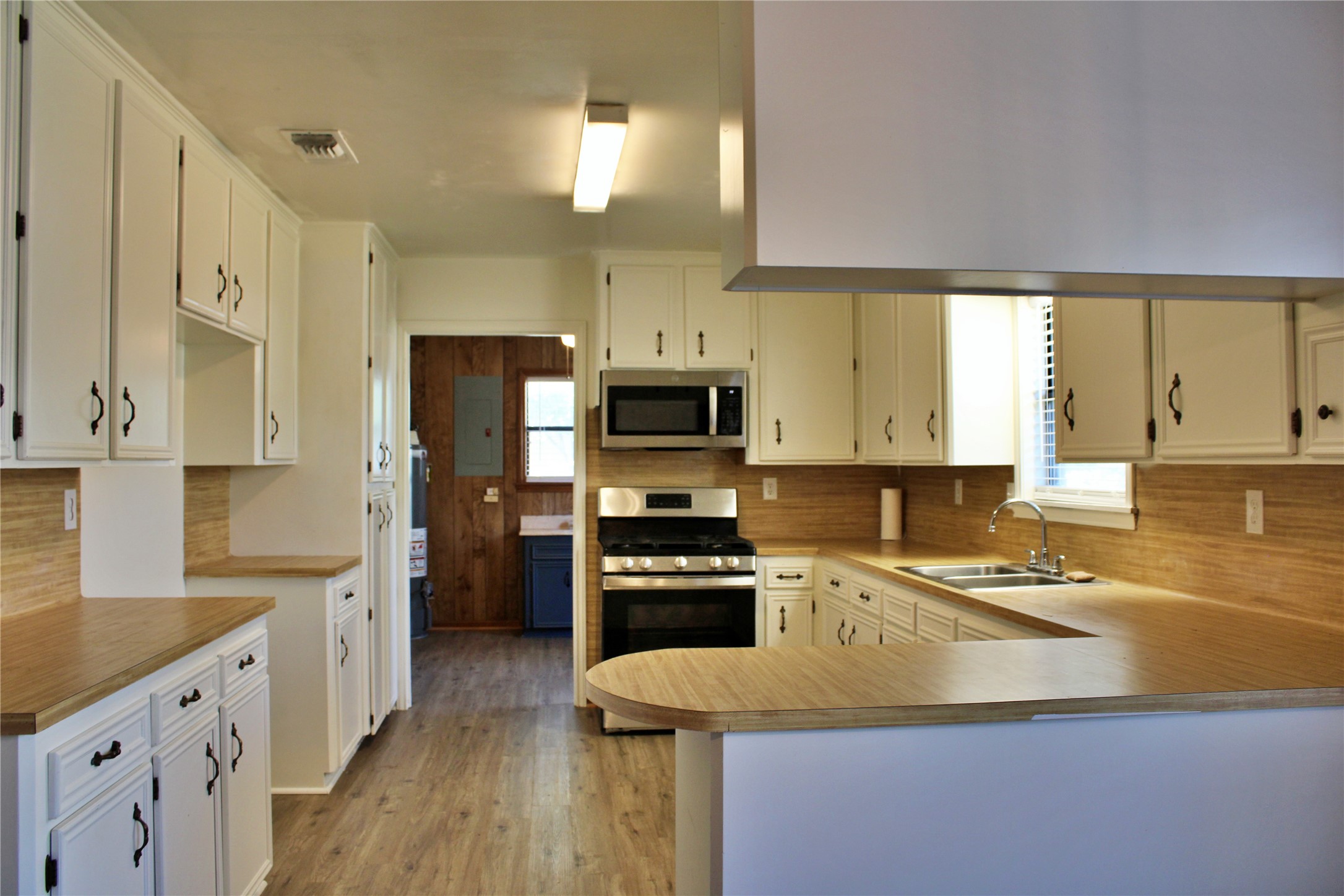 1126 Jackson Street Columbus, TX 78934 - Photo 6 of 40 a kitchen with a sink a counter top space stainless steel appliances and cabinets
