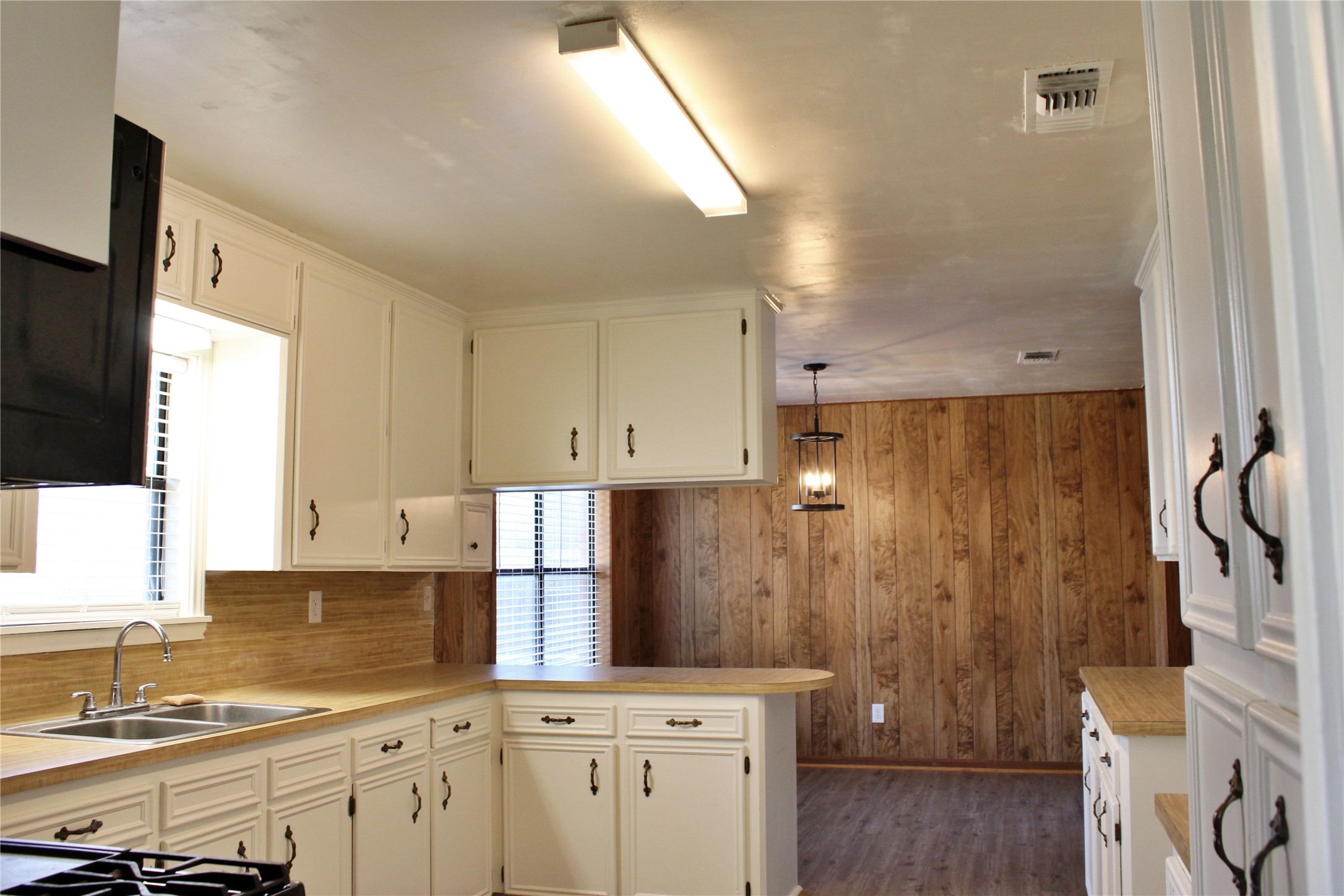 1126 Jackson Street Columbus, TX 78934 - Photo 7 of 40 a kitchen with stainless steel appliances a refrigerator sink and cabinets