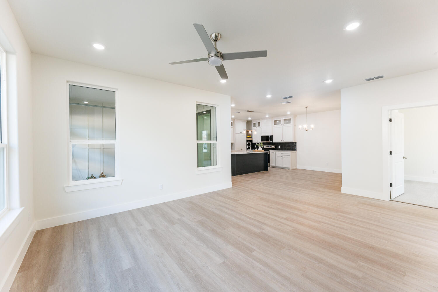 3819 58th Street Lubbock, TX 79413 - Photo 12 of 63 a view of a electric appliances in kitchen and empty room with wooden floor