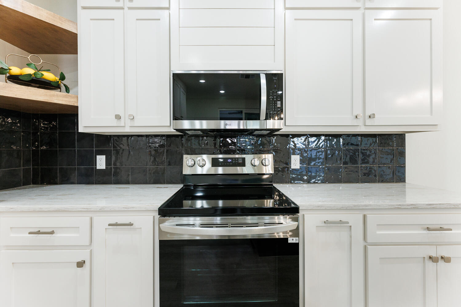 3819 58th Street Lubbock, TX 79413 - Photo 19 of 63 a kitchen with stainless steel appliances granite countertop a stove and a microwave