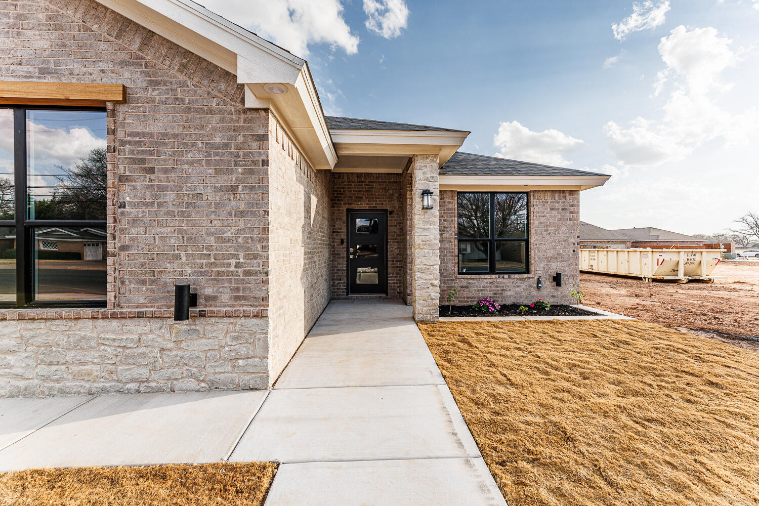 3819 58th Street Lubbock, TX 79413 - Photo 2 of 63 a view of a brick house with an outdoor space