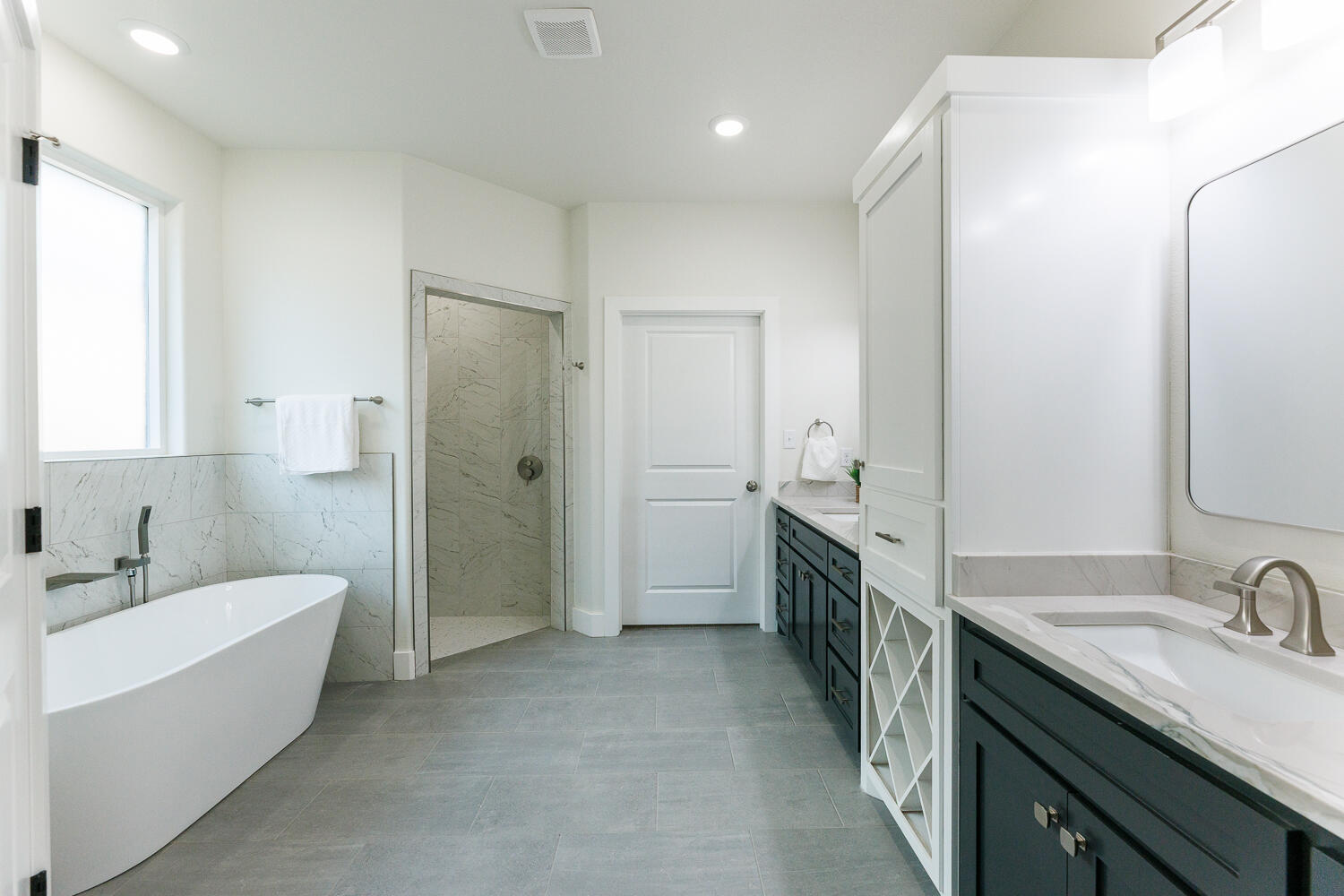 3819 58th Street Lubbock, TX 79413 - Photo 34 of 63 a bathroom with a double vanity sink a mirror and a bathtub