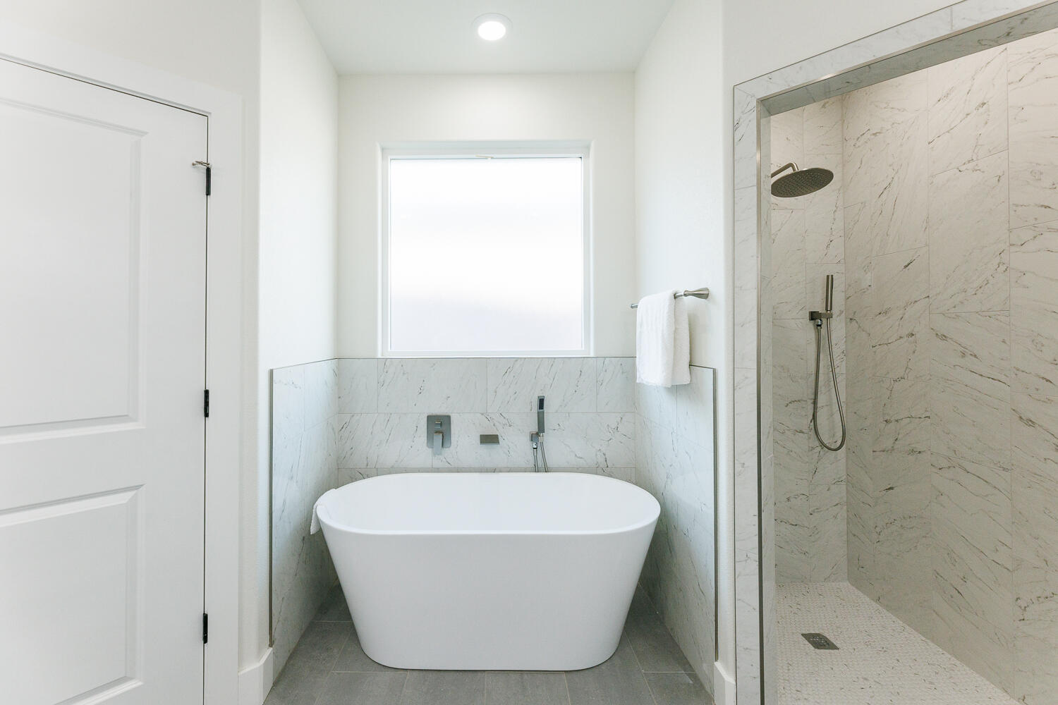 3819 58th Street Lubbock, TX 79413 - Photo 37 of 63 a bathroom with a white tub shower and a sink