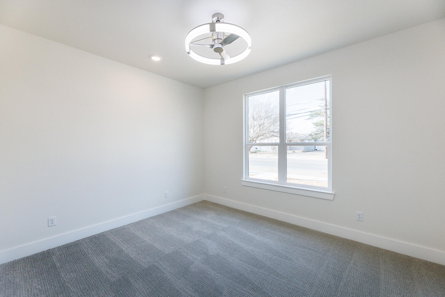 3819 58th Street Lubbock, TX 79413 - Photo 41 of 63 an empty room with a window and a fan