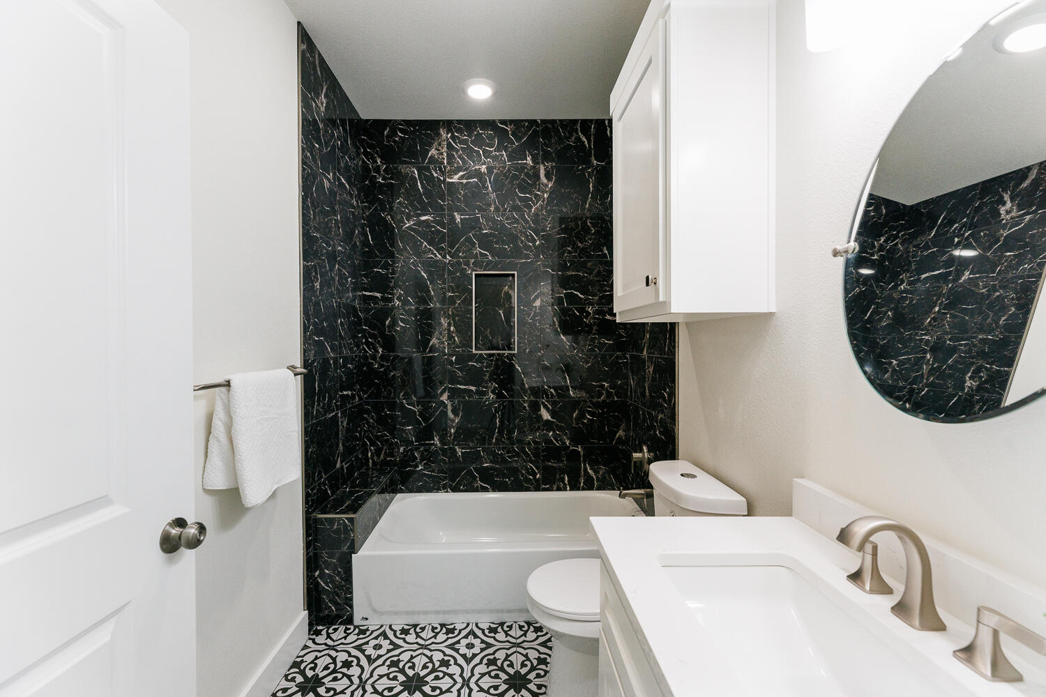 3819 58th Street Lubbock, TX 79413 - Photo 43 of 63 a bathroom with a sink toilet and shower