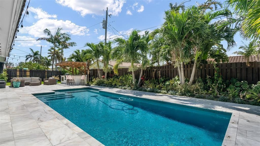 a swimming pool with outdoor seating and yard