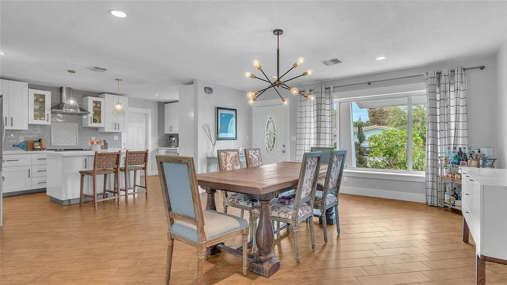 2800 Northeast 53rd Street Lighthouse Point, FL 33064 - Photo 13 of 34 a view of a dining room with furniture window and wooden floor