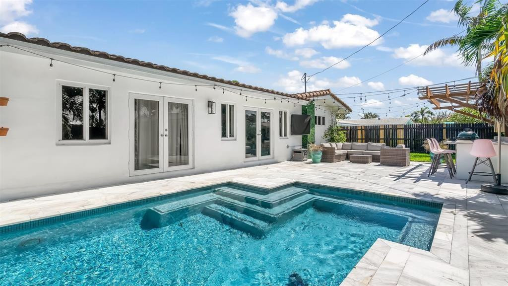 2800 Northeast 53rd Street Lighthouse Point, FL 33064 - Photo 2 of 34 a view of a house with backyard porch and patio