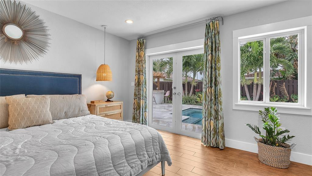 2800 Northeast 53rd Street Lighthouse Point, FL 33064 - Photo 22 of 34 a bedroom with a large bed and a potted plant