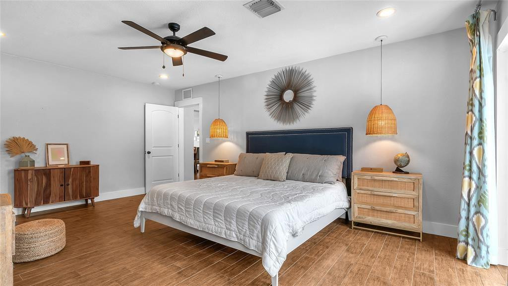 2800 Northeast 53rd Street Lighthouse Point, FL 33064 - Photo 23 of 34 a bedroom with a bed and wooden floor