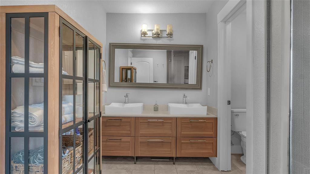 2800 Northeast 53rd Street Lighthouse Point, FL 33064 - Photo 26 of 34 a bathroom with a double vanity sink and mirror