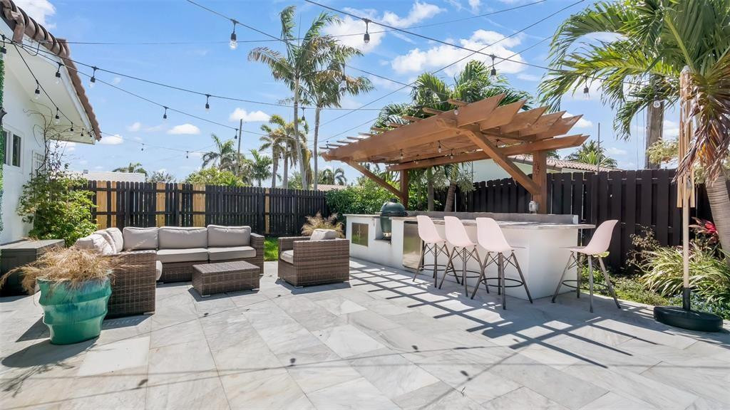 2800 Northeast 53rd Street Lighthouse Point, FL 33064 - Photo 3 of 34 a view of a patio with couches table and chairs potted plants