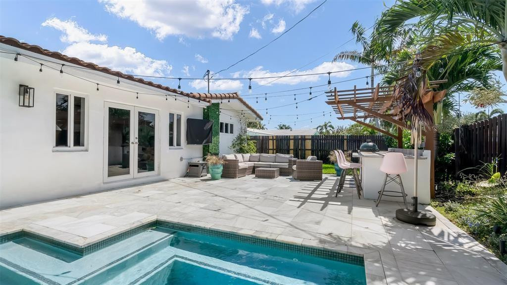 2800 Northeast 53rd Street Lighthouse Point, FL 33064 - Photo 32 of 34 a view of a patio with a table and chairs under an umbrella