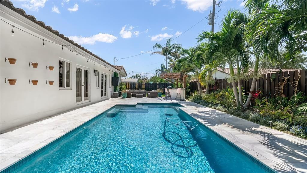 2800 Northeast 53rd Street Lighthouse Point, FL 33064 - Photo 33 of 34 a view of a house with backyard and sitting area