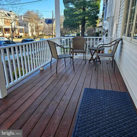 a view of balcony with wooden floor and outdoor seating