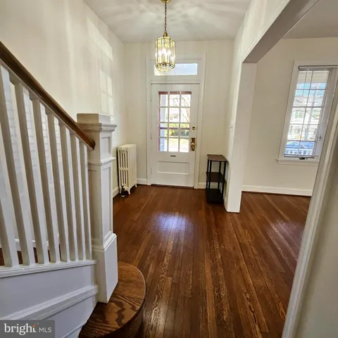 a view of entryway with wooden floor and door