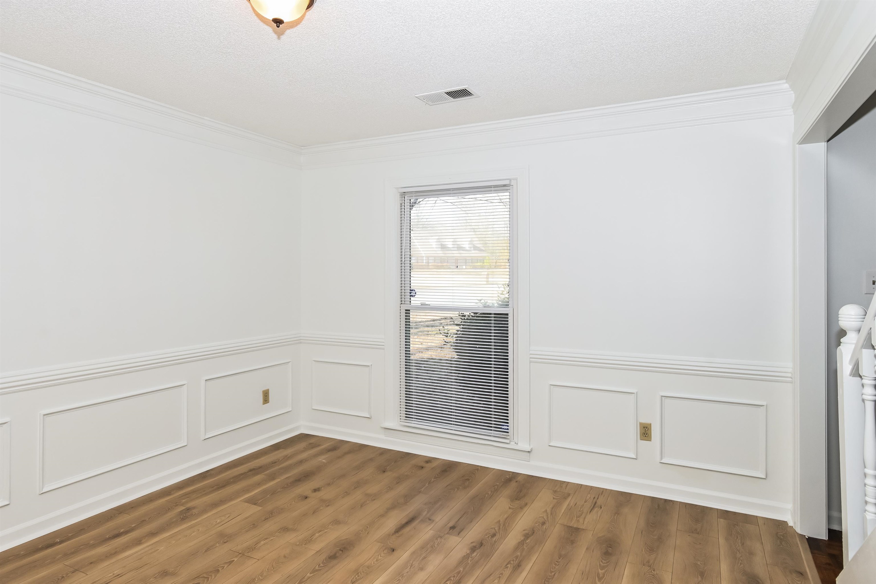 3656 Beaver Run Drive Collierville, TN 38017 - Photo 13 of 18 Spare room featuring ornamental molding, wainscoting, wood finished floors, and a textured ceiling
