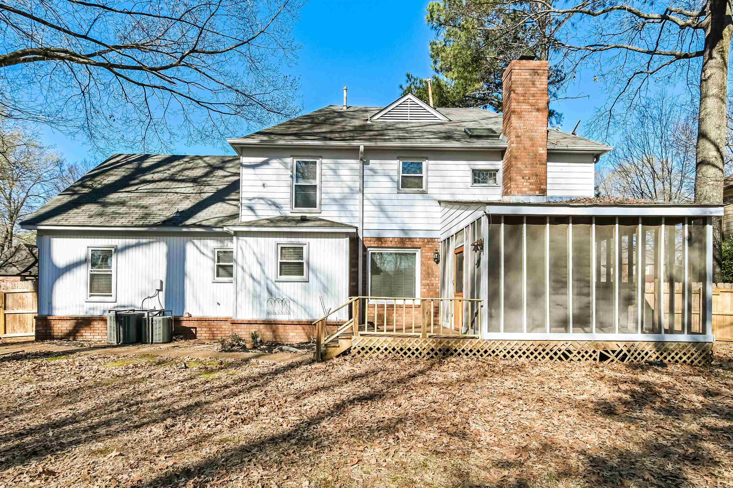 3656 Beaver Run Drive Collierville, TN 38017 - Photo 15 of 18 Back of house featuring a sunroom, a deck, a chimney, and roof with shingles