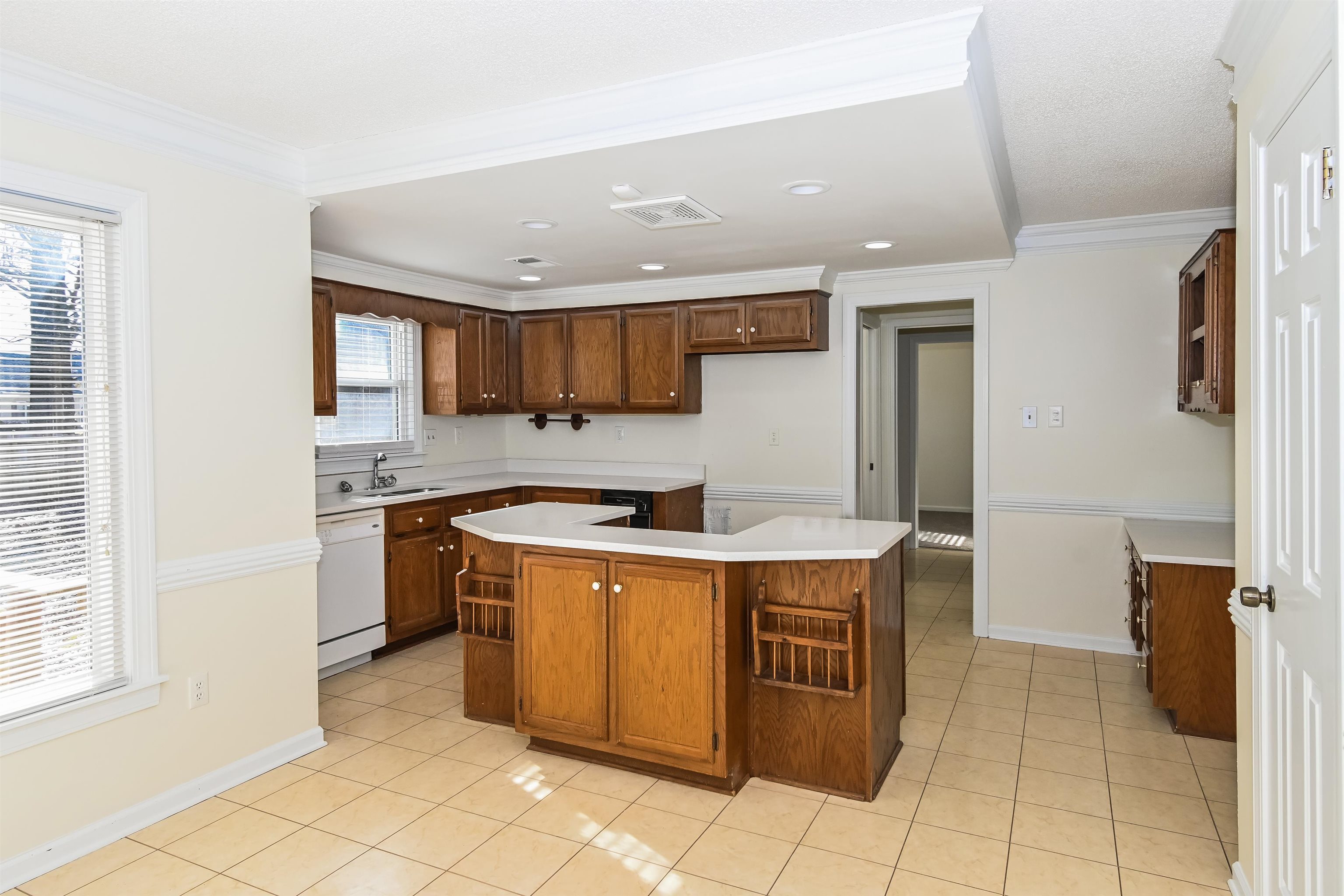 3656 Beaver Run Drive Collierville, TN 38017 - Photo 4 of 18 Kitchen featuring light tile patterned flooring, light countertops, recessed lighting, ornamental molding, and white dishwasher