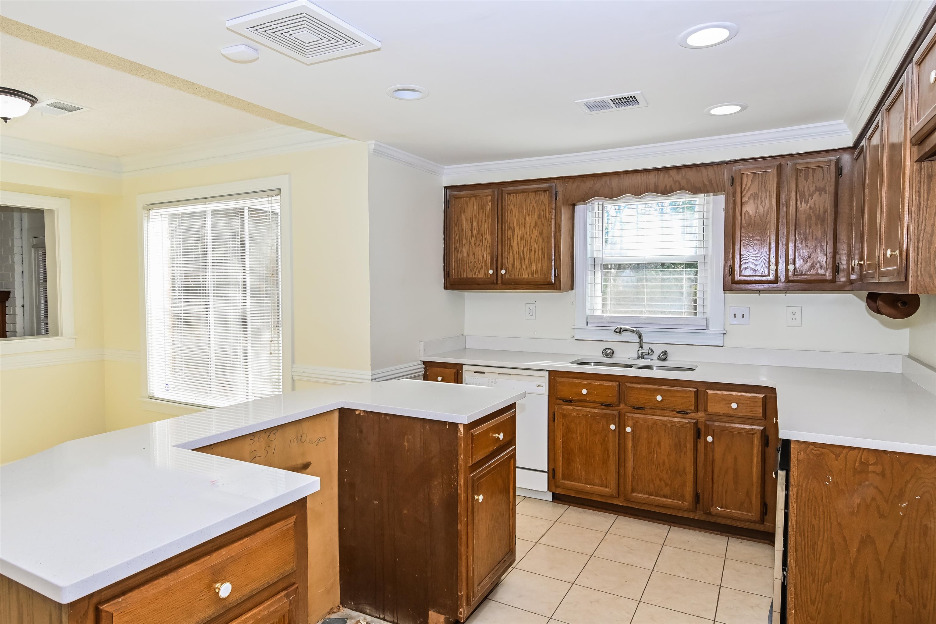 3656 Beaver Run Drive Collierville, TN 38017 - Photo 5 of 18 Kitchen with ornamental molding, light countertops, dishwasher, wood finish cabinets, and light tile patterned floors