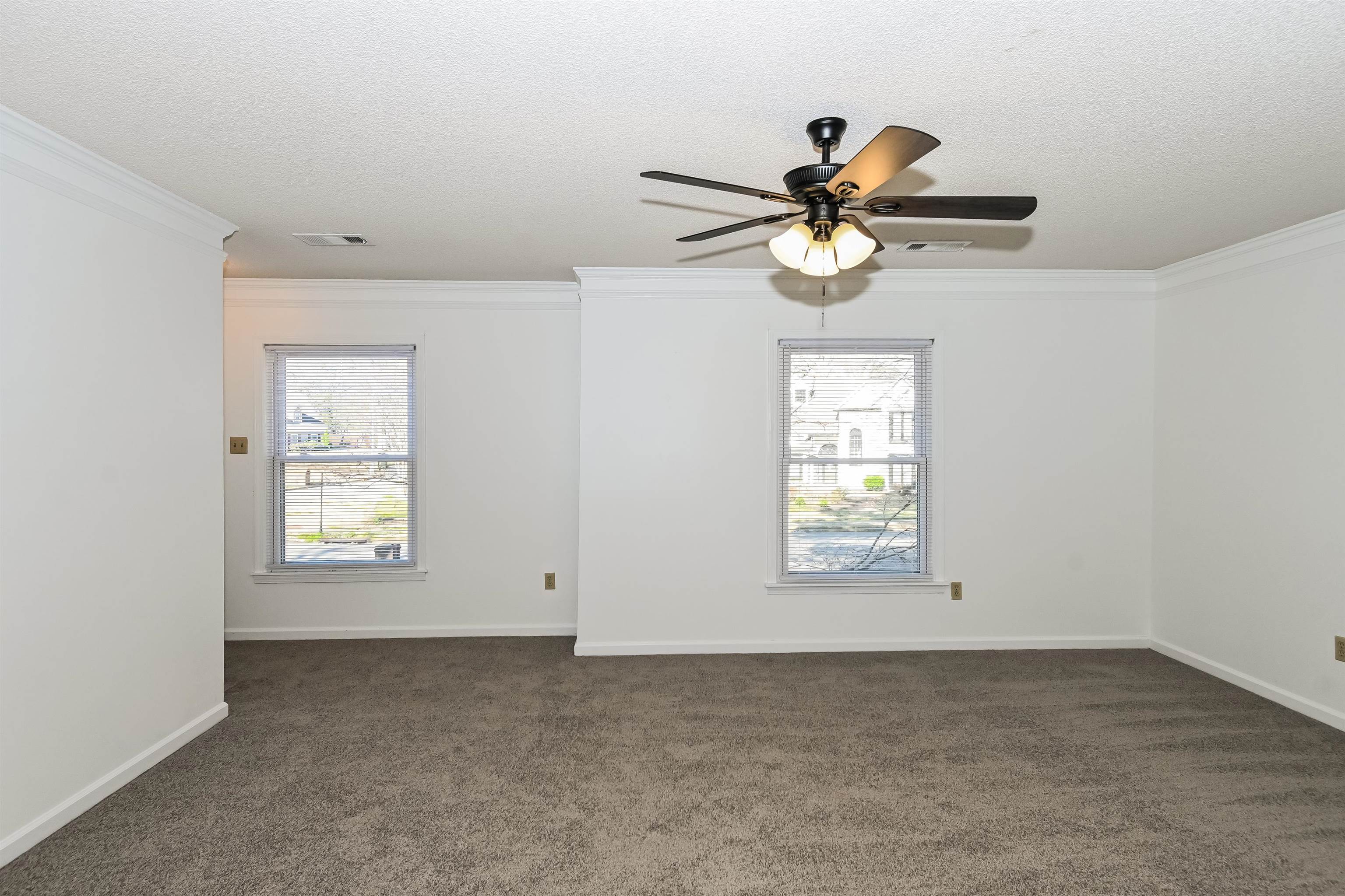 3656 Beaver Run Drive Collierville, TN 38017 - Photo 7 of 18 Spare room with crown molding, dark colored carpet, a textured ceiling, and a ceiling fan