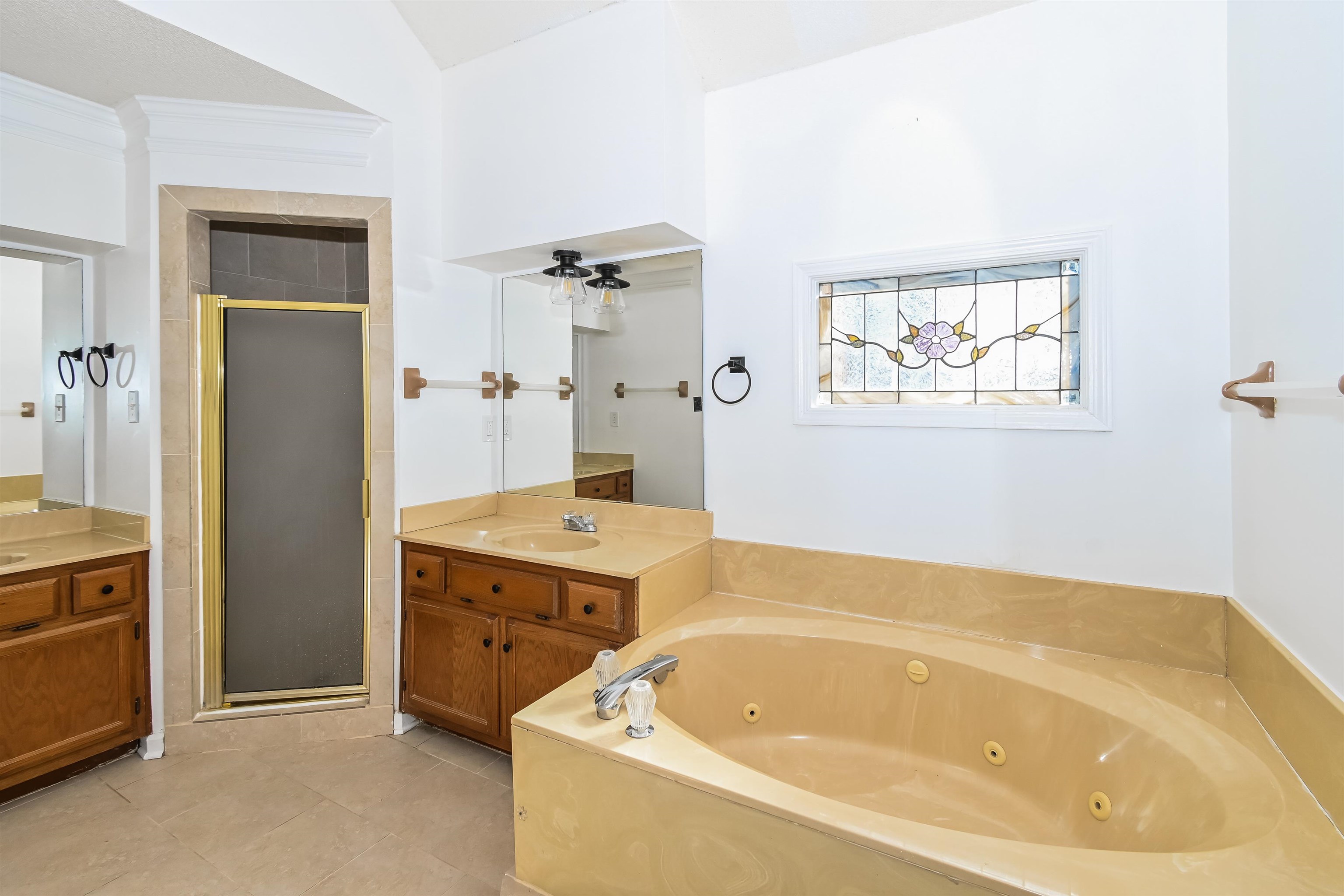 3656 Beaver Run Drive Collierville, TN 38017 - Photo 9 of 18 Bathroom featuring a stall shower, two vanities, a tub with jets, ornamental molding, and light tile patterned floors