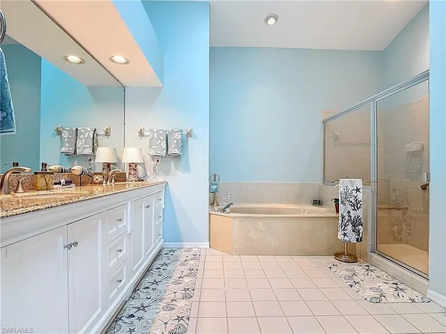 a bathroom with a tub sink and a mirror