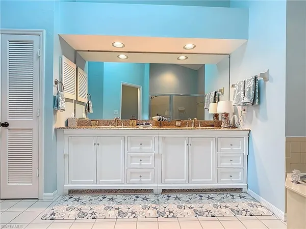 a spacious bathroom with a sink a mirror and a bathtub
