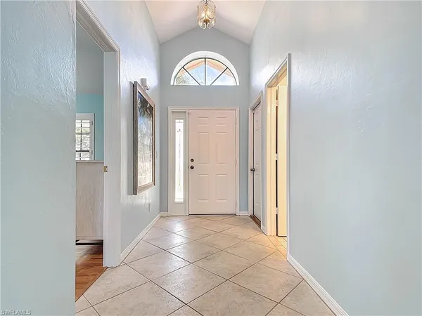 an empty room with wooden floor and a window