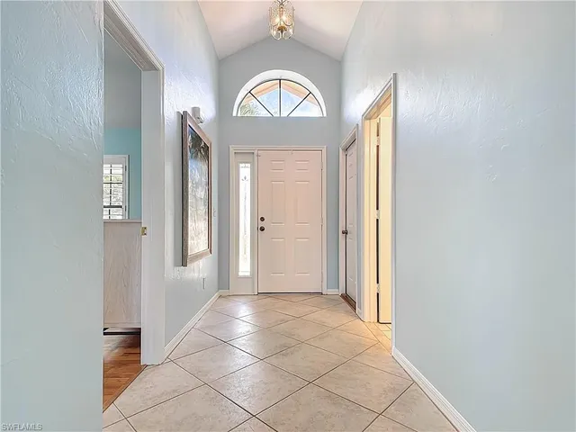 an empty room with wooden floor and a window