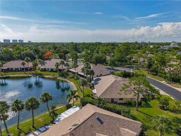 an aerial view of residential houses with outdoor space and river