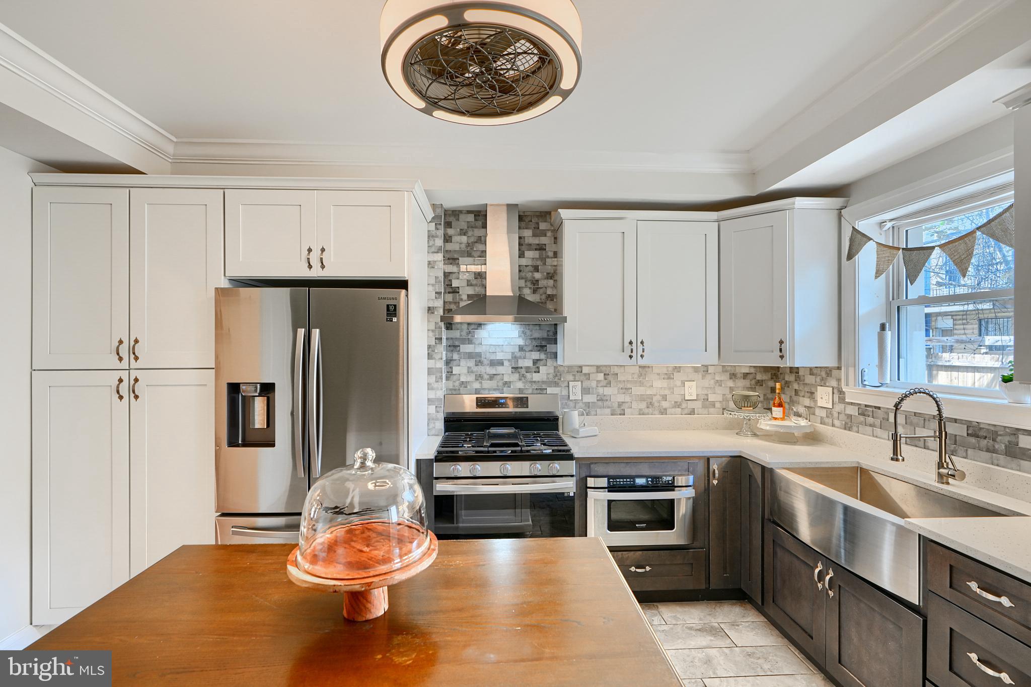 a kitchen with stainless steel appliances a stove a refrigerator and a sink