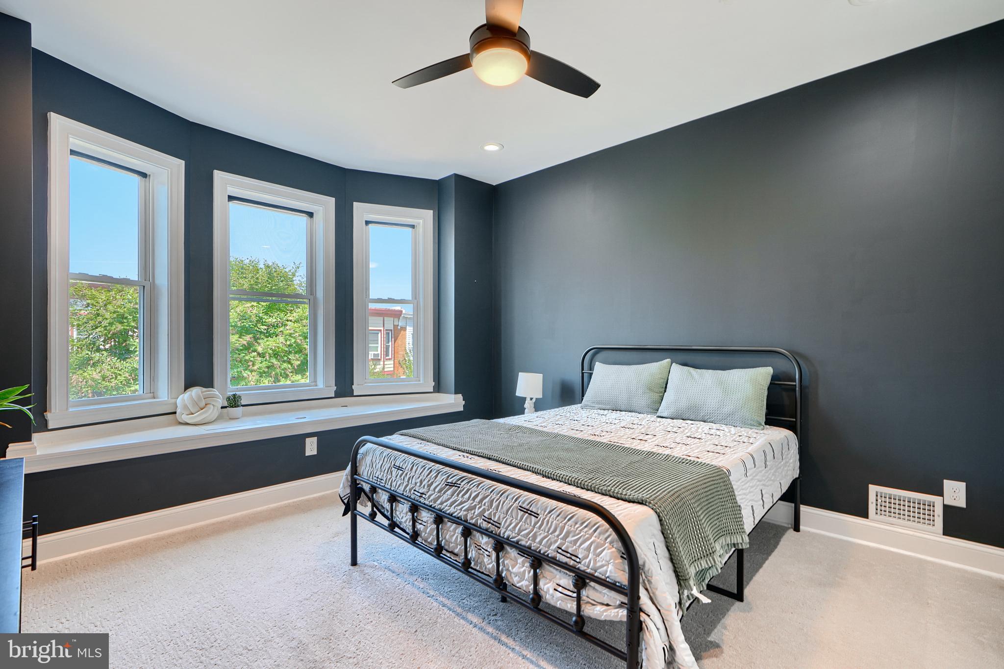 119 South Potomac Street Baltimore, MD 21224 - Photo 11 of 26 a bedroom with a large bed and a large window