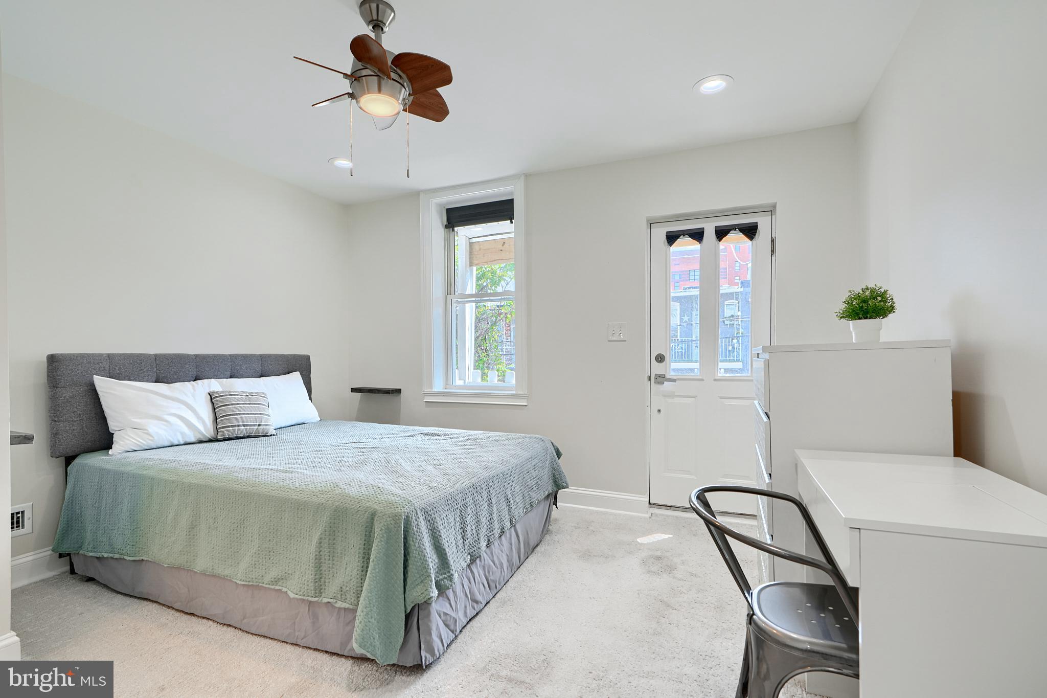 119 South Potomac Street Baltimore, MD 21224 - Photo 13 of 26 a bedroom with a bed a window with the potted plant