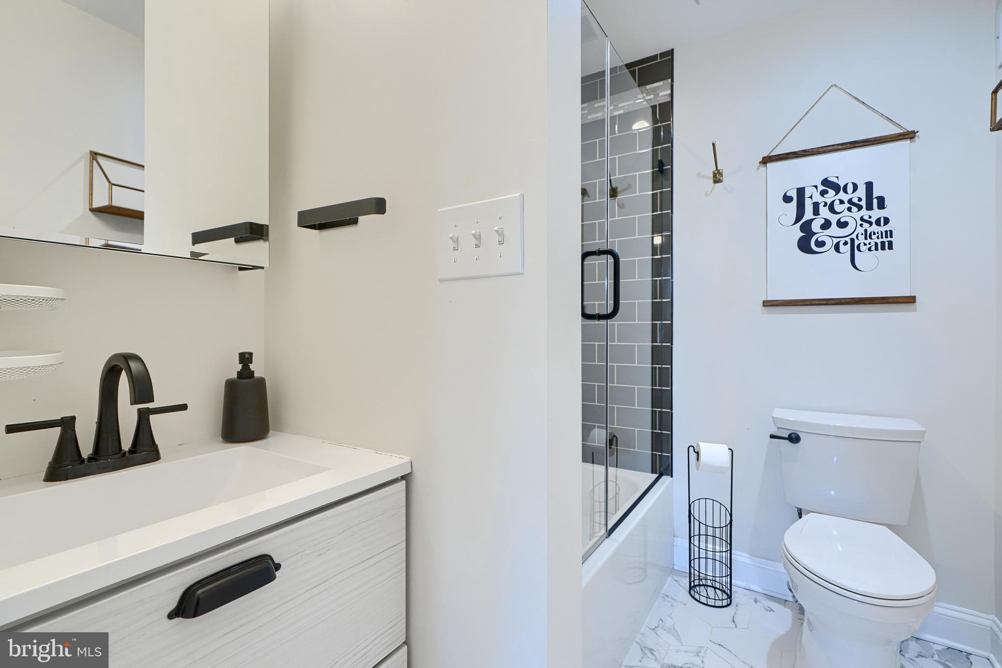 119 South Potomac Street Baltimore, MD 21224 - Photo 15 of 26 a bathroom with a toilet sink and shower