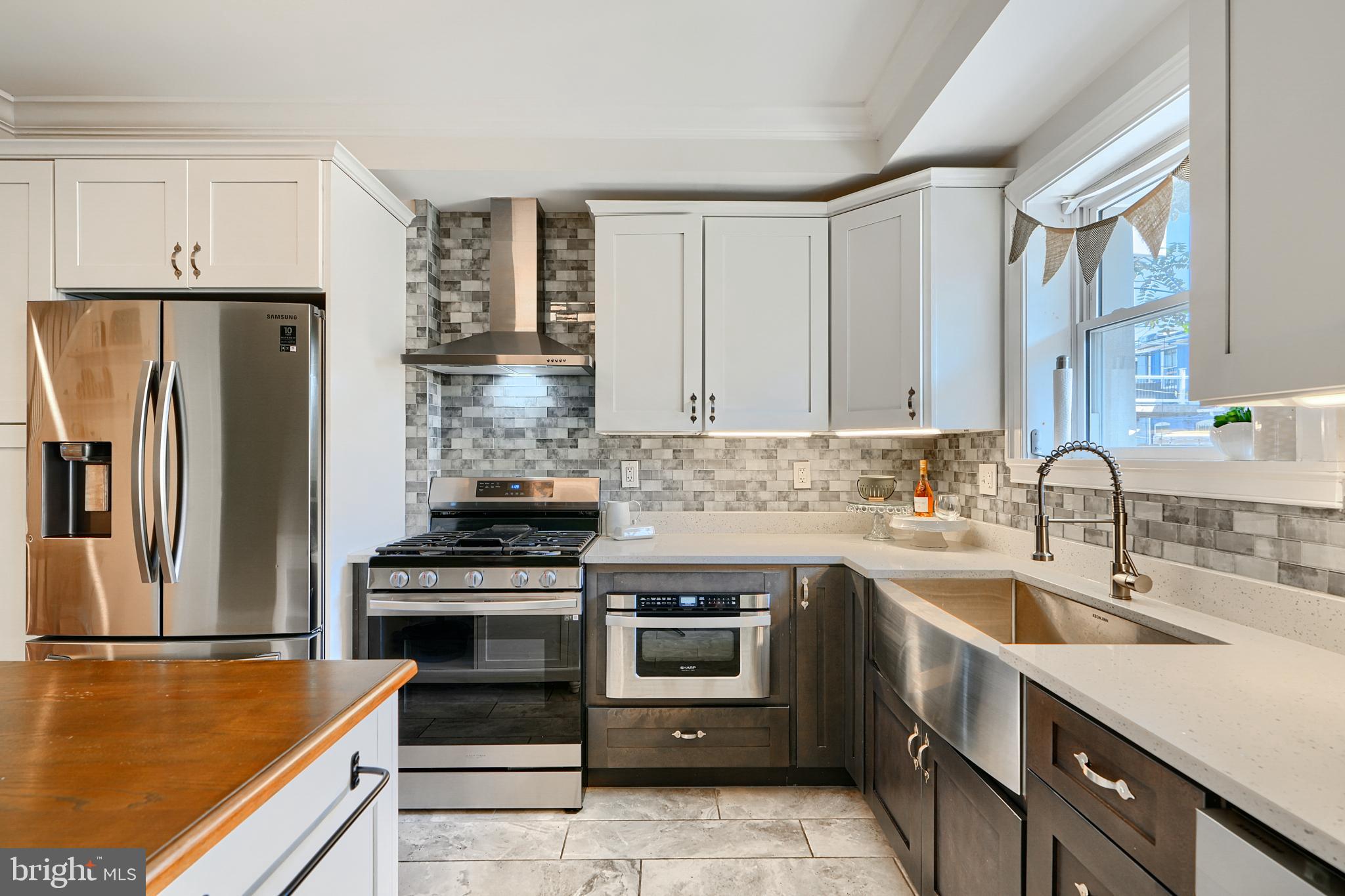 119 South Potomac Street Baltimore, MD 21224 - Photo 2 of 26 a kitchen with a stove and a refrigerator