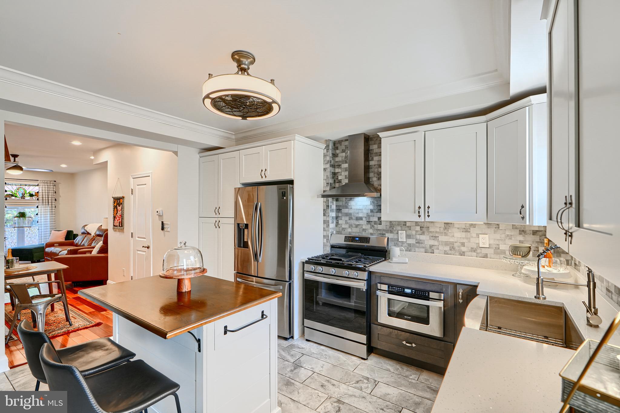 119 South Potomac Street Baltimore, MD 21224 - Photo 3 of 26 a kitchen with stainless steel appliances a stove a sink and a refrigerator
